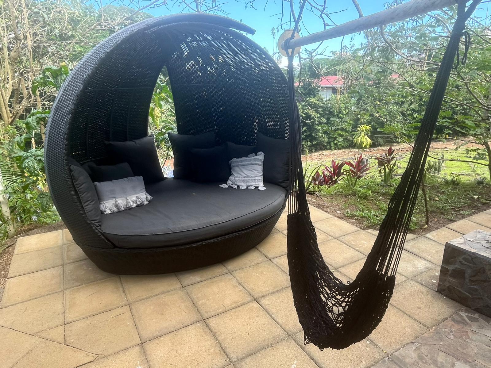 Hammock and shaded lounge pod in the garden