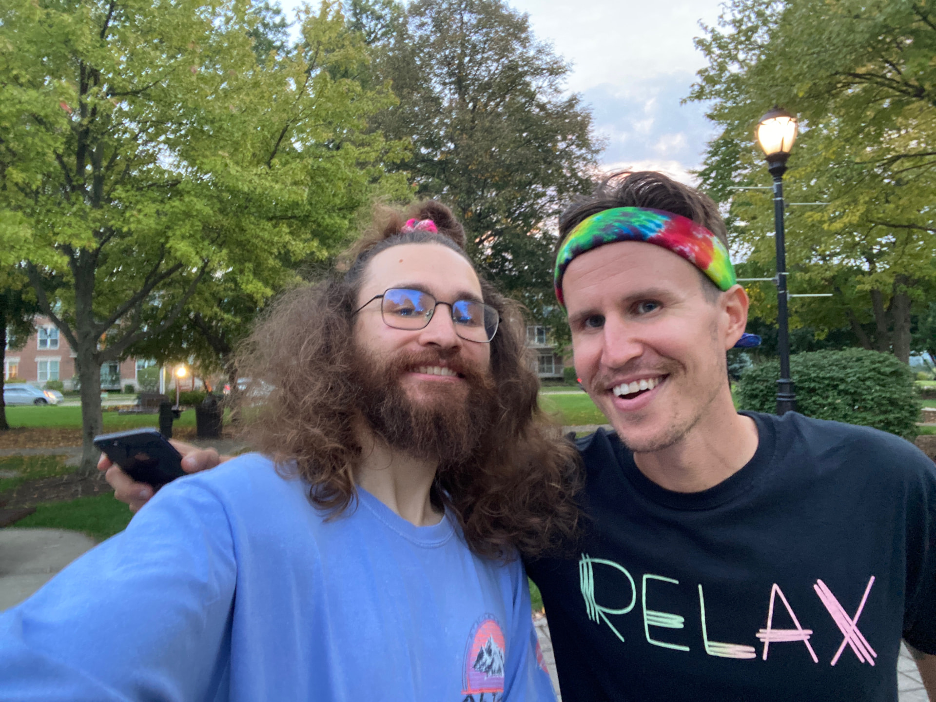 David and Kai smiling together in a park at dusk
