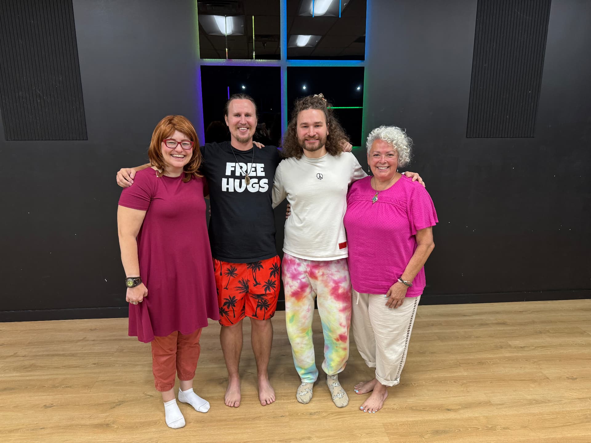 Vilija, Kai, David and Yolanda standing barefoot together on a studio dance floor